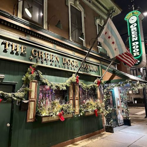 Green Door Tavern Chicago exterior with hanging sign on Orleans Street River North
